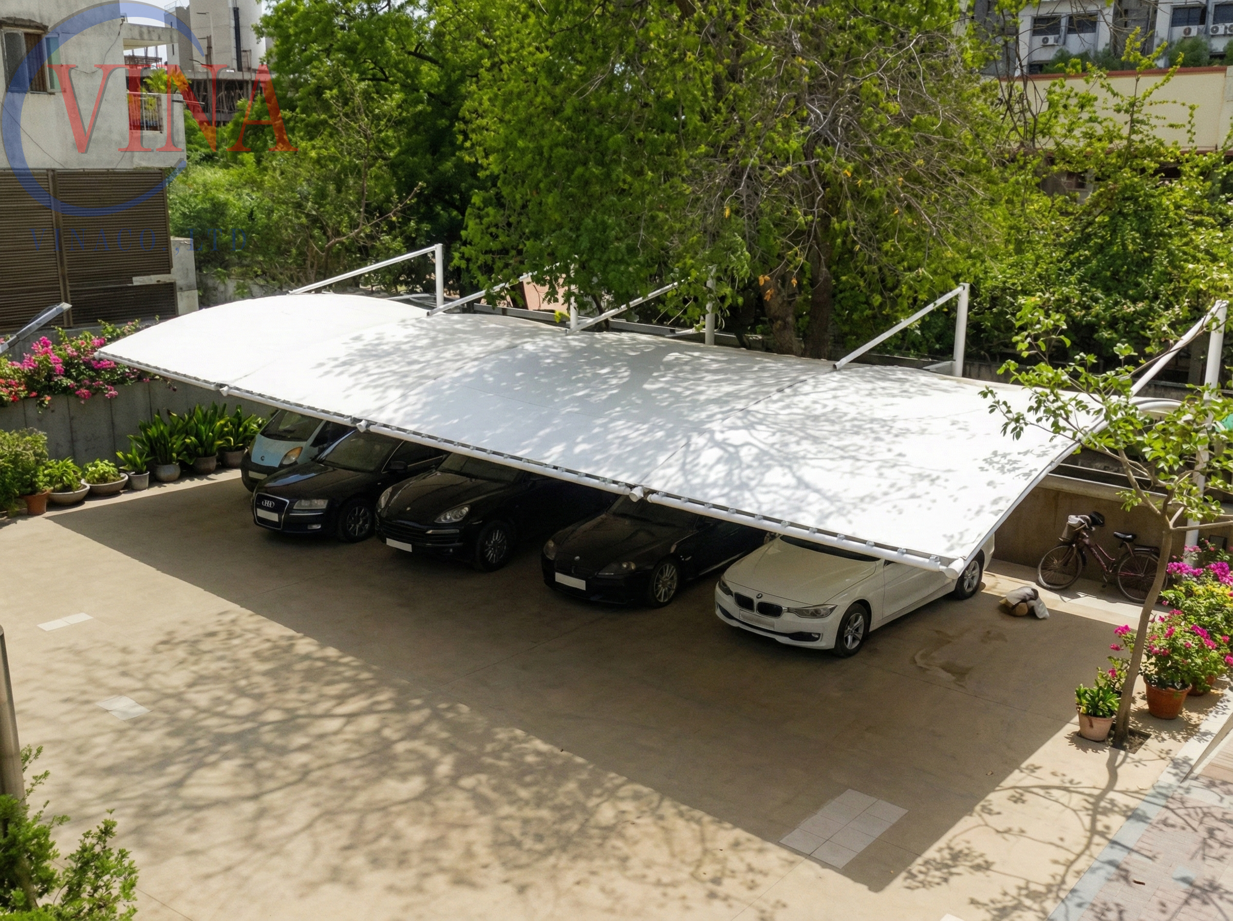 Nhà xe mái vòm bạt căng che được 4 xe hơi sang trọng trước biệt thự.